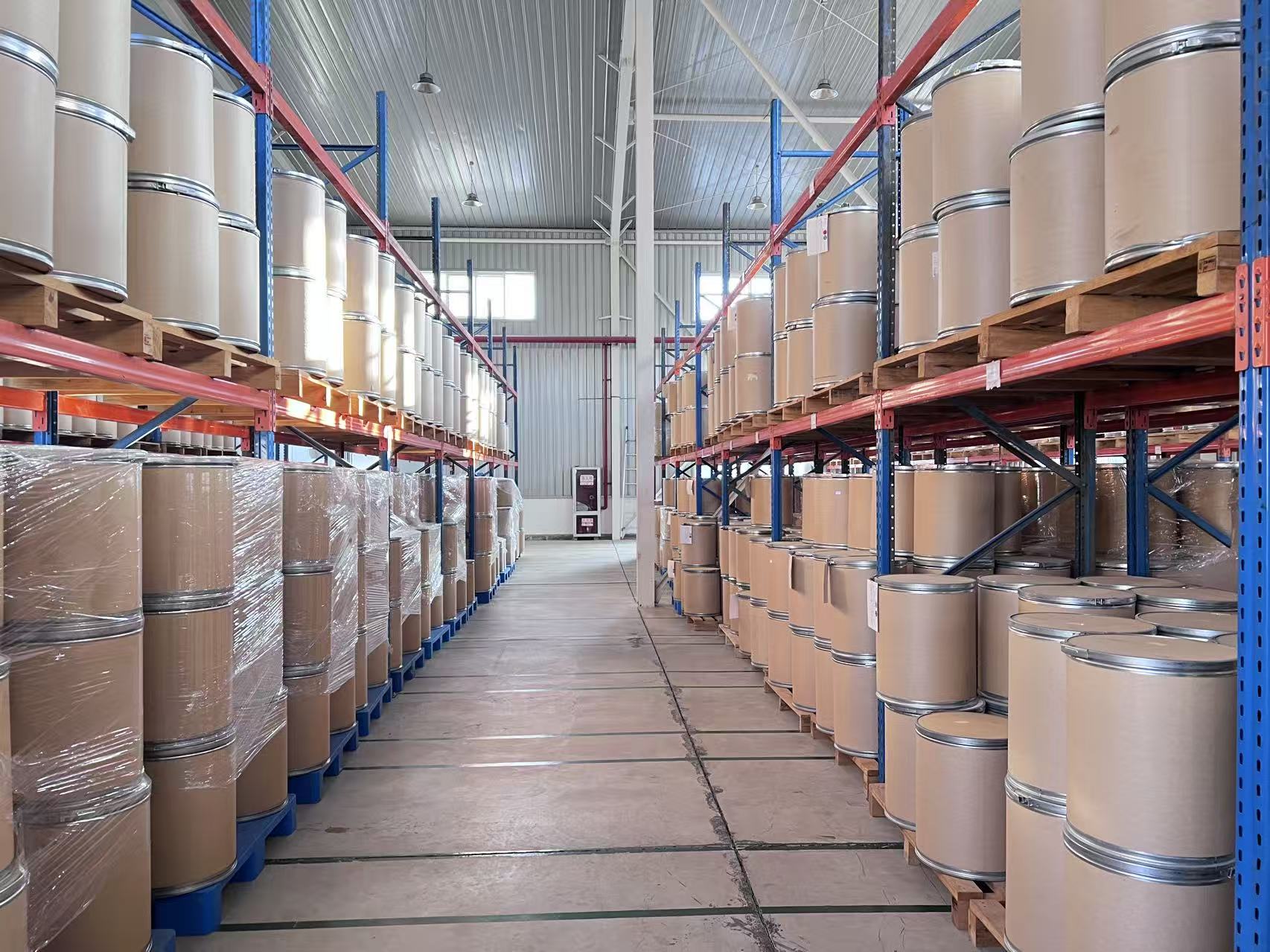 GoodNutrition Bio warehouse aisle with packaged raw material drums